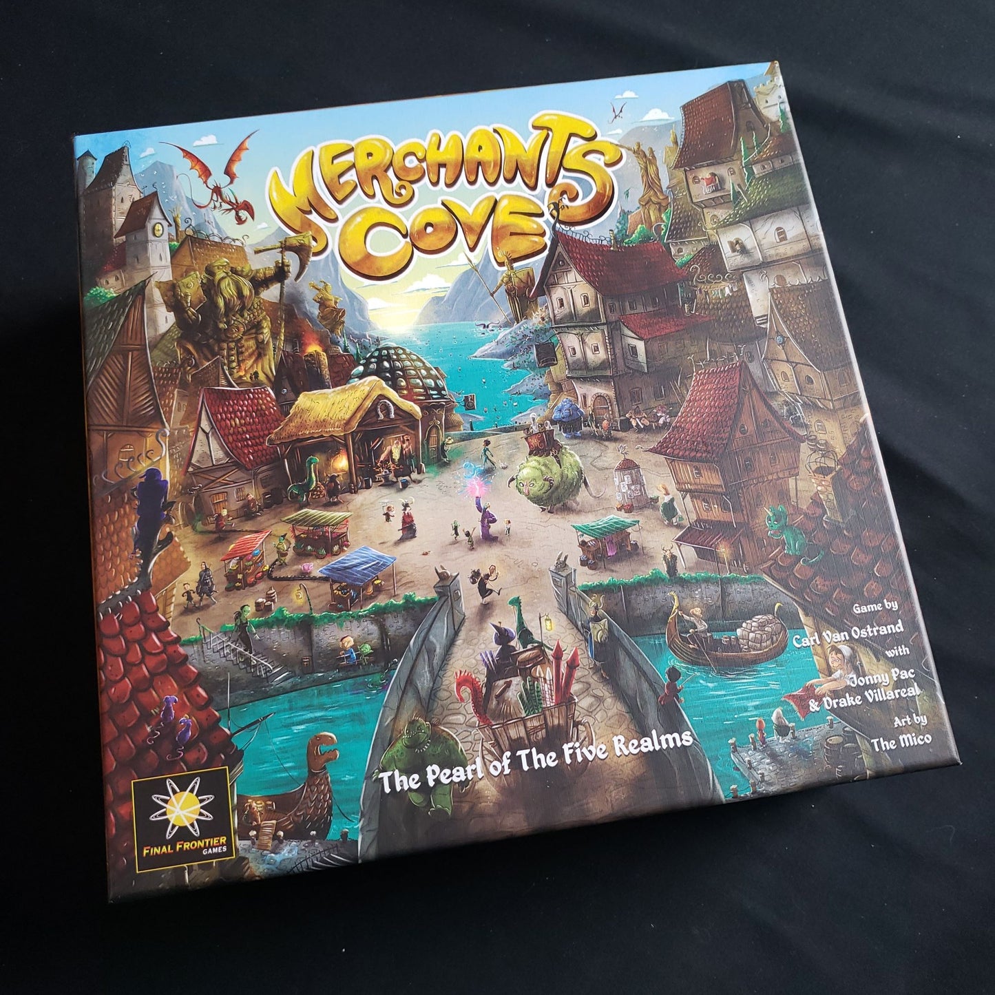 Image shows the front cover of the box of the Merchants Cove board game