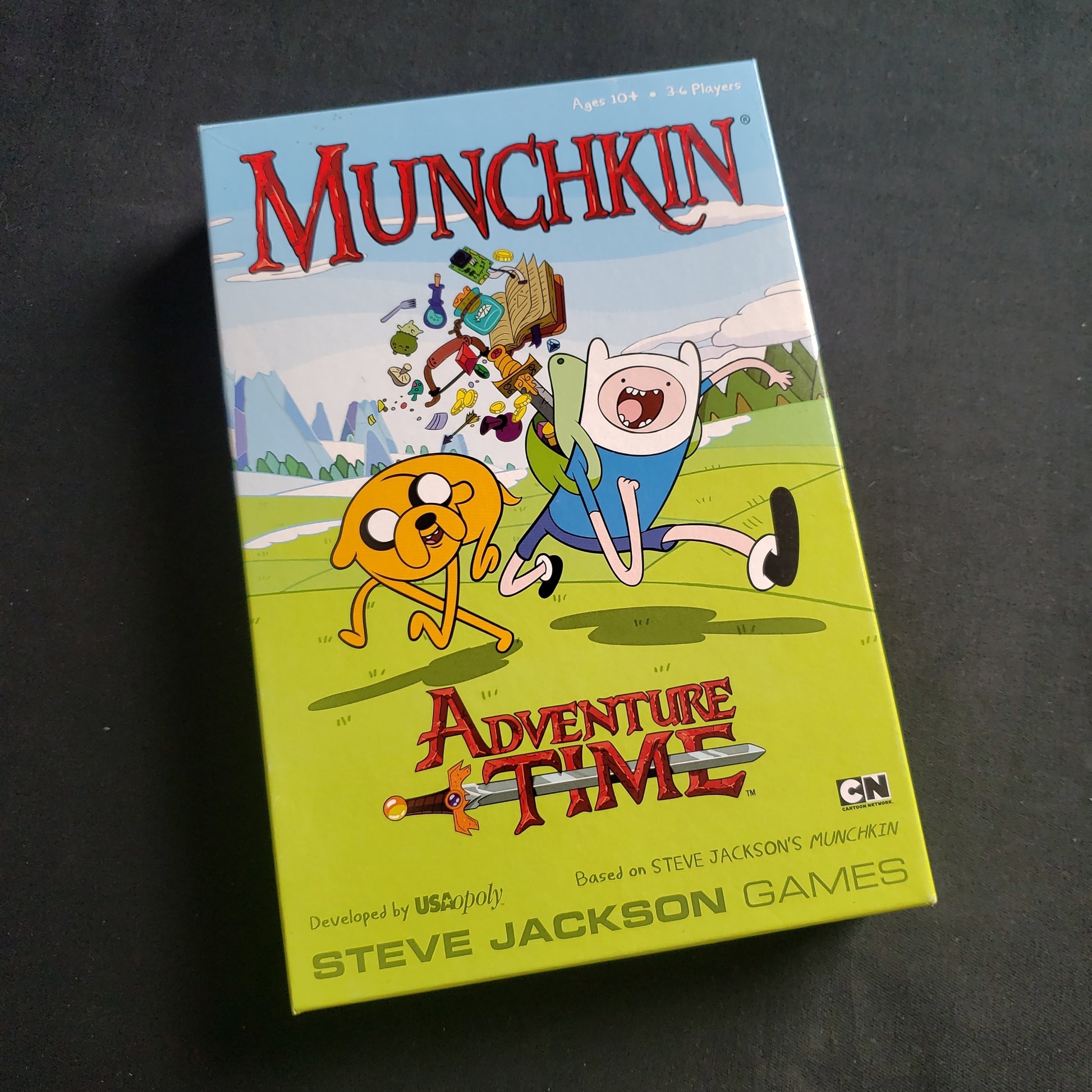 Image shows the front cover of the box of the Munchkin Adventure Time card game