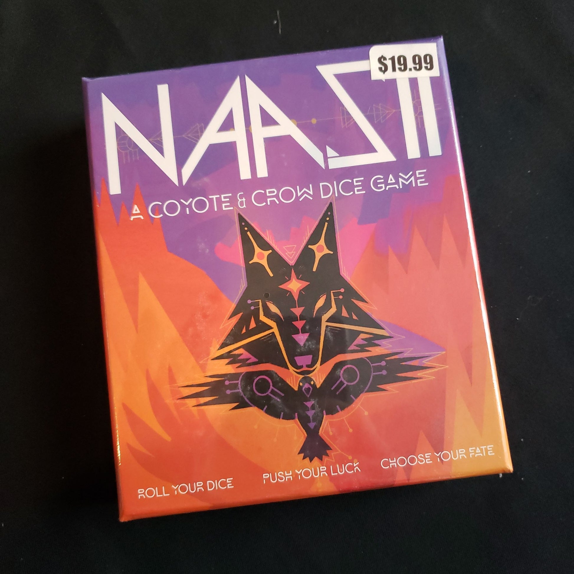 Image shows the front cover of the box of the Naasii dice game