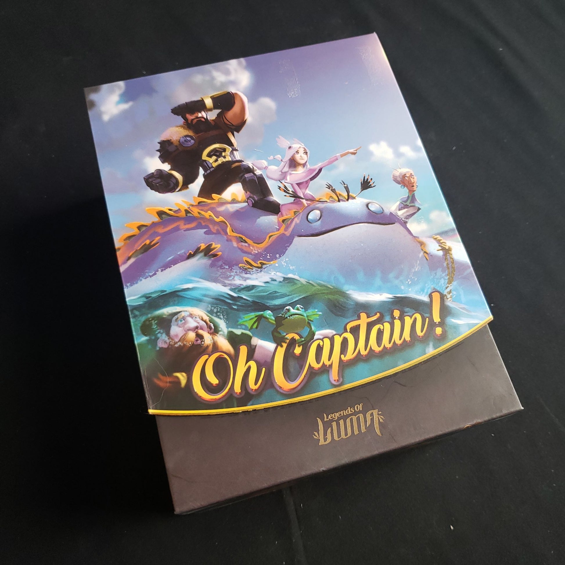 Image shows the front cover of the box of the Oh Captain! card game