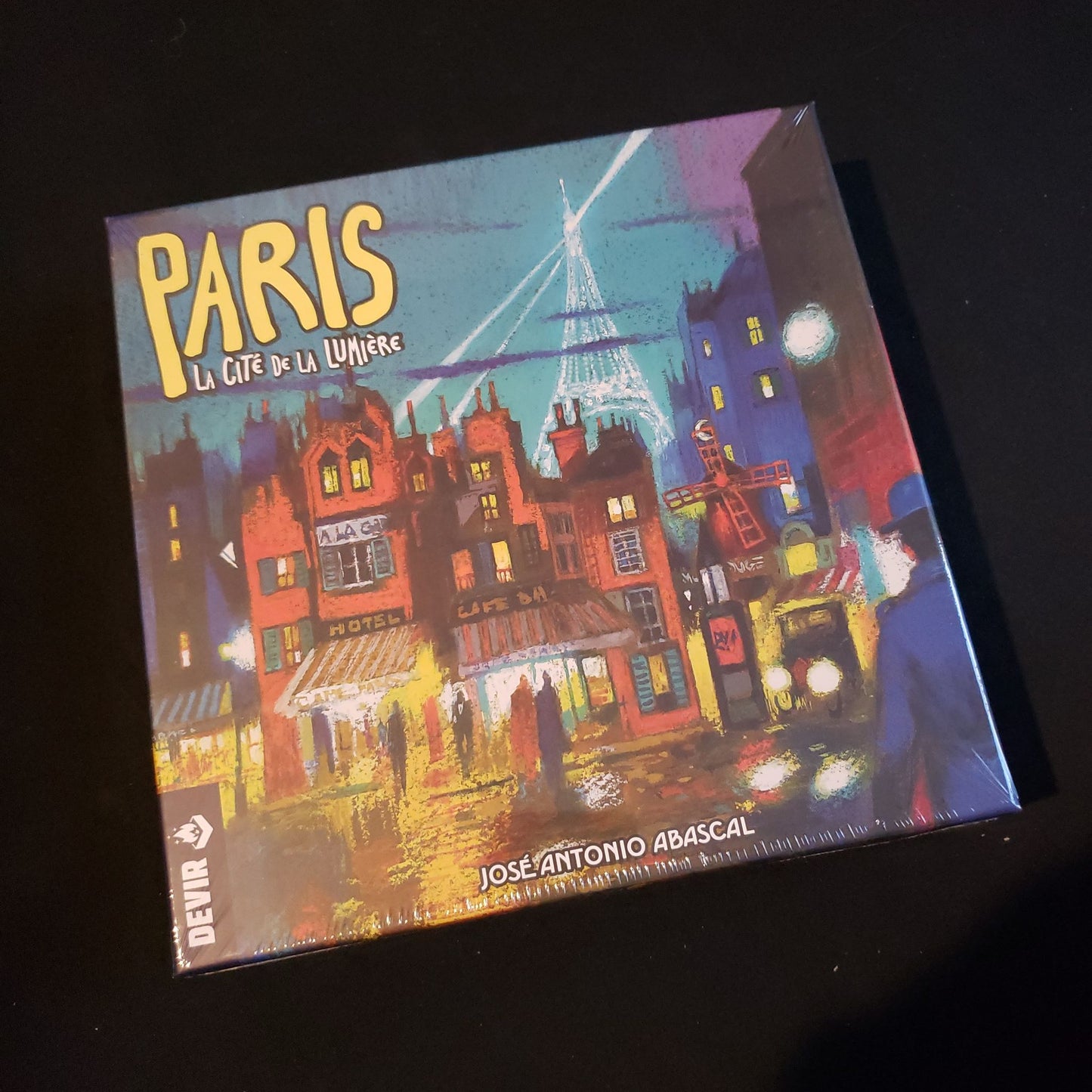 Image shows the front cover of the box of the Paris: La Cite de la Lumiere board game