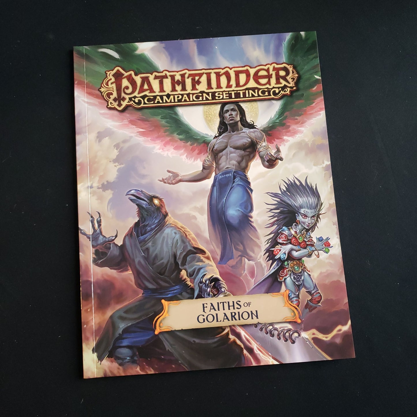 Image shows the front cover of the faiths of Golarion book for the Pathfinder First Edition roleplaying game