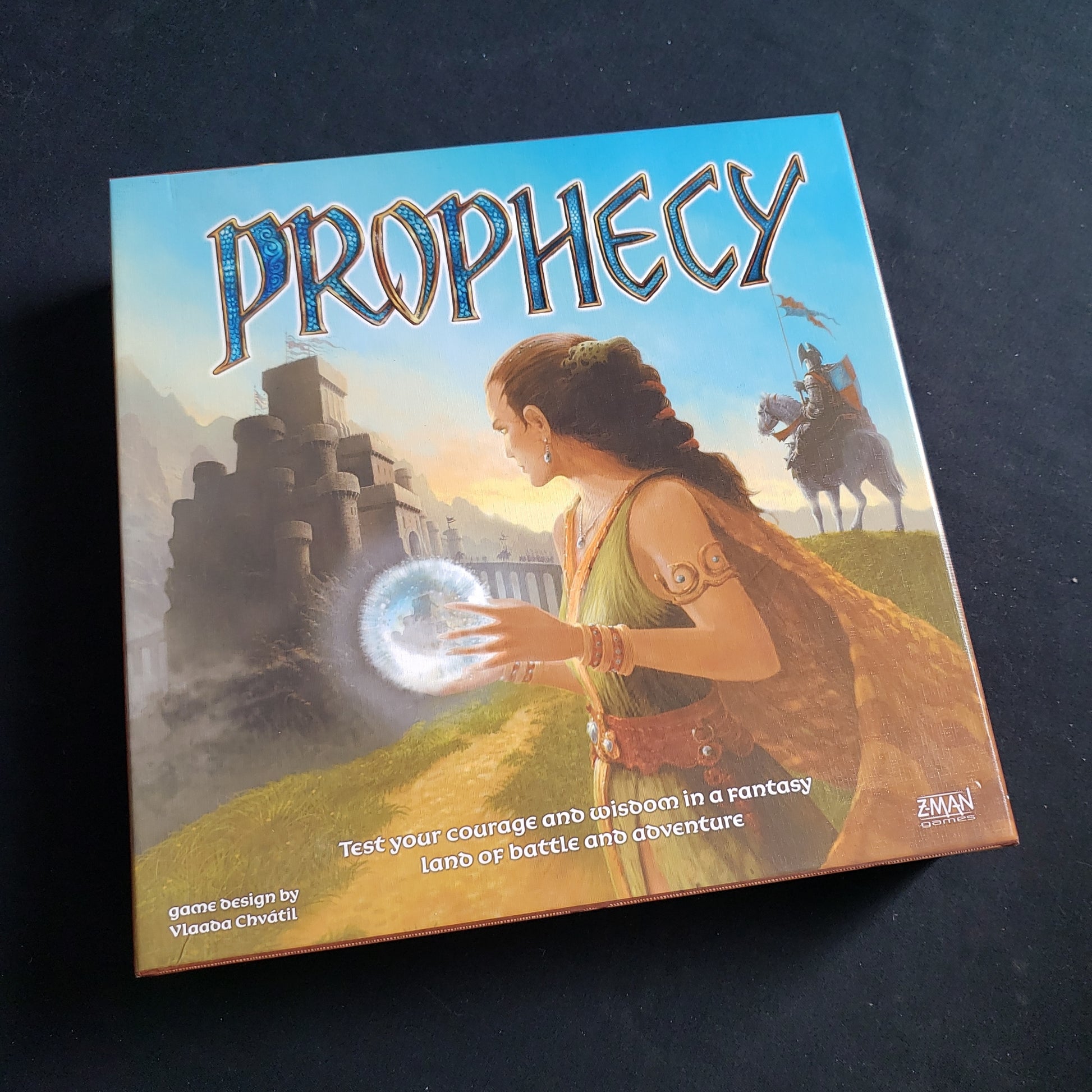 Image shows the front cover of the box of the Prophecy board game