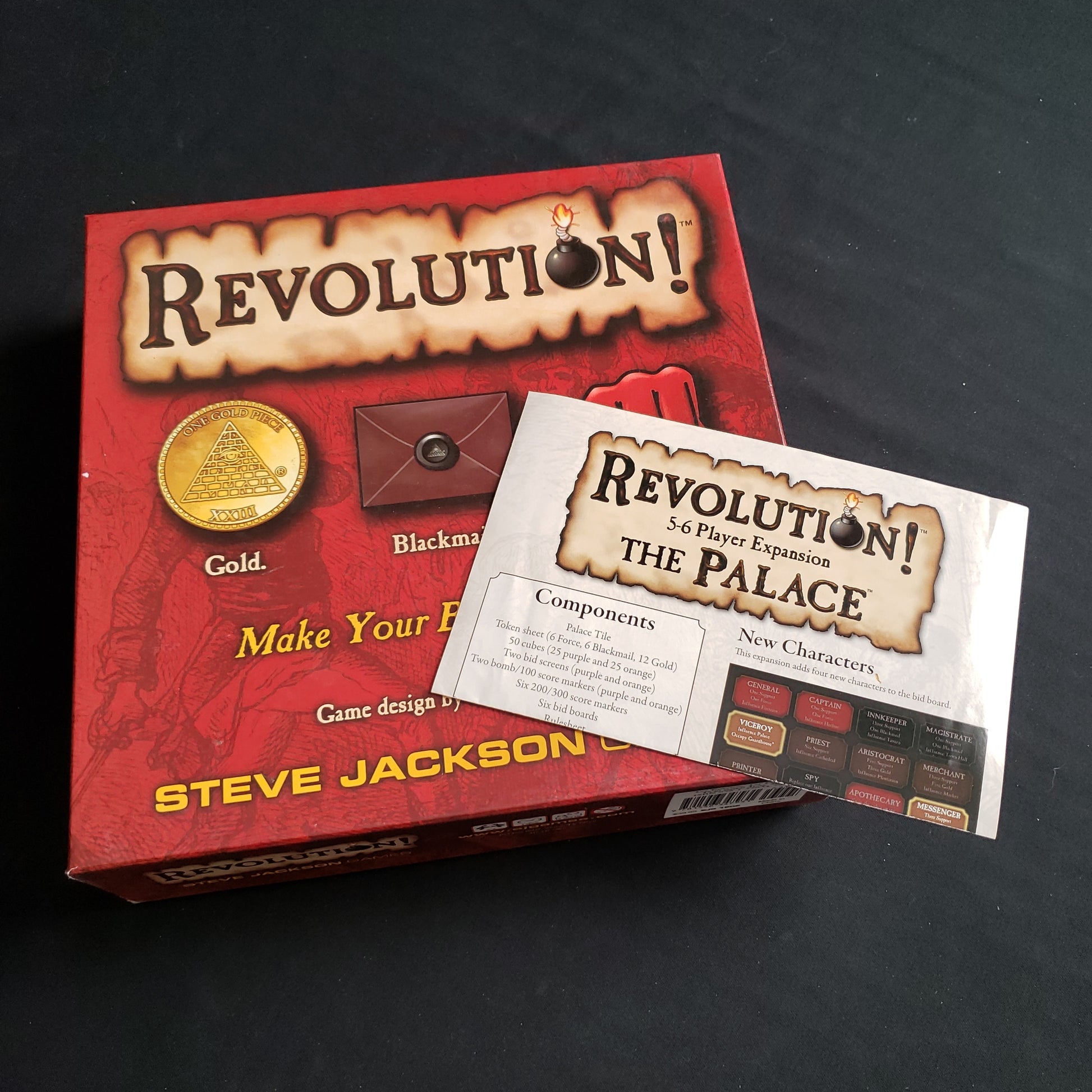 Image shows the front cover of the box of the Revolution board game, along with the instructions for "The Palace" 5-6 Player expansion sitting on top of it