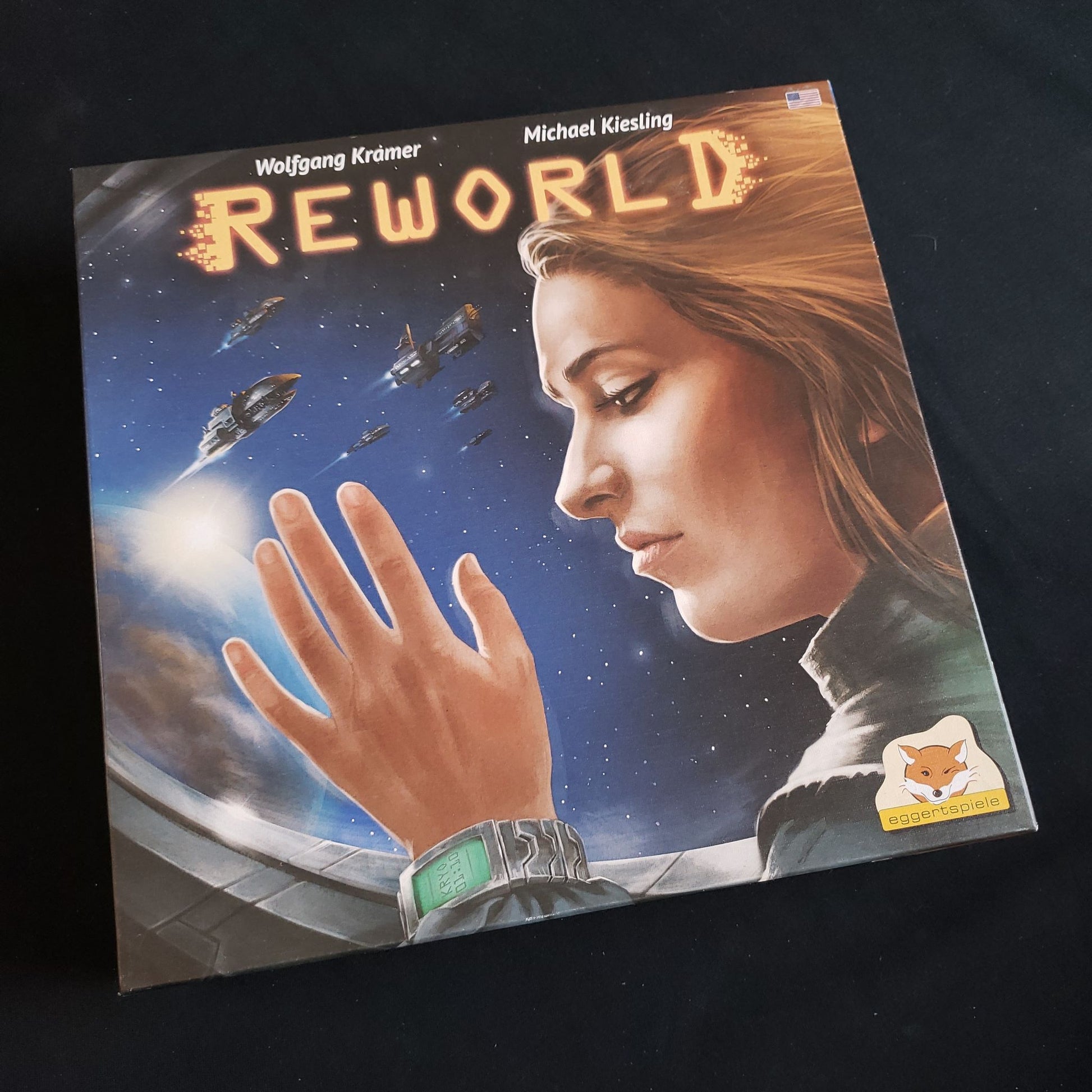Image shows the front cover of the box of the Reworld board game