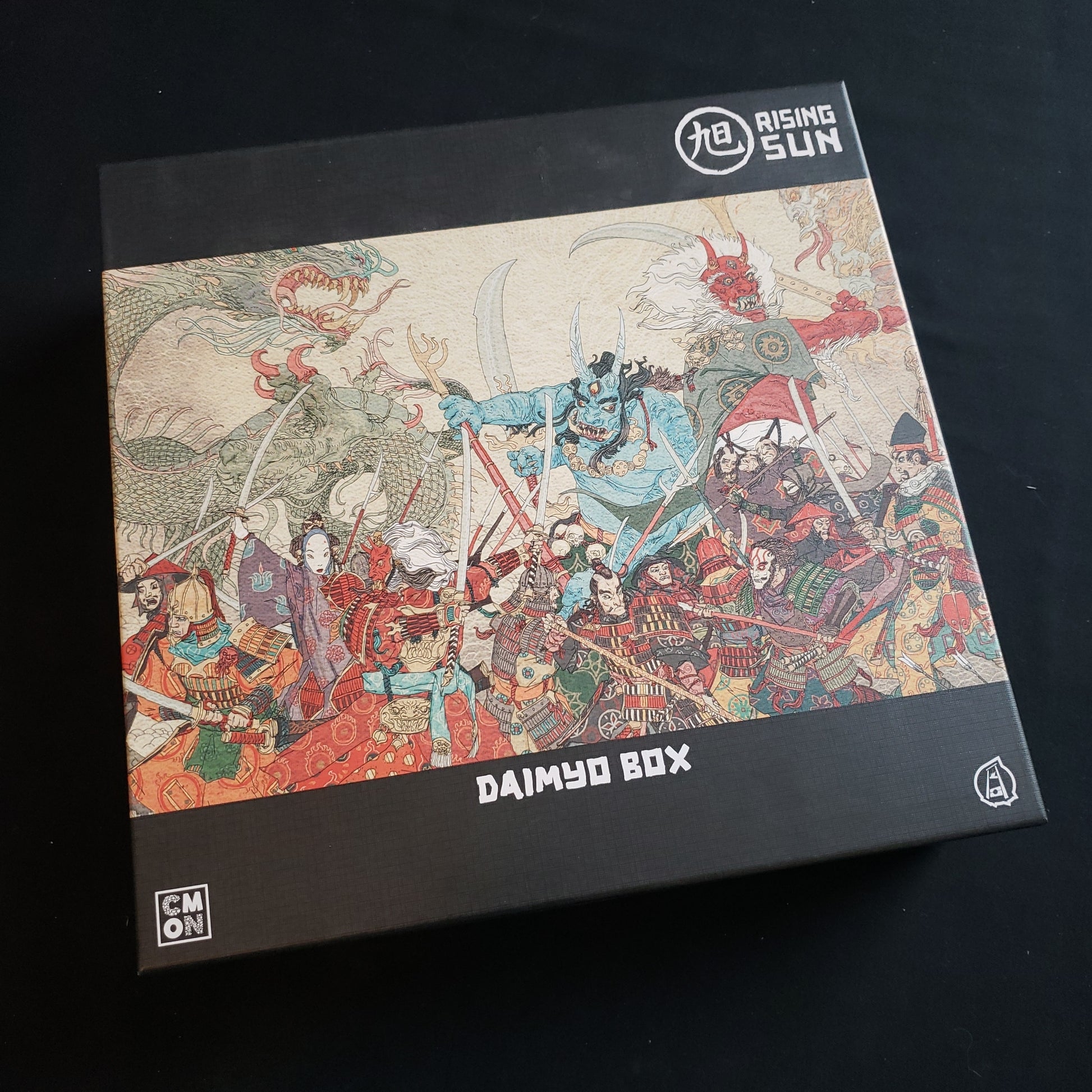 Image shows the front cover of the box of the Daimyo box expansion for the Rising Sun board game