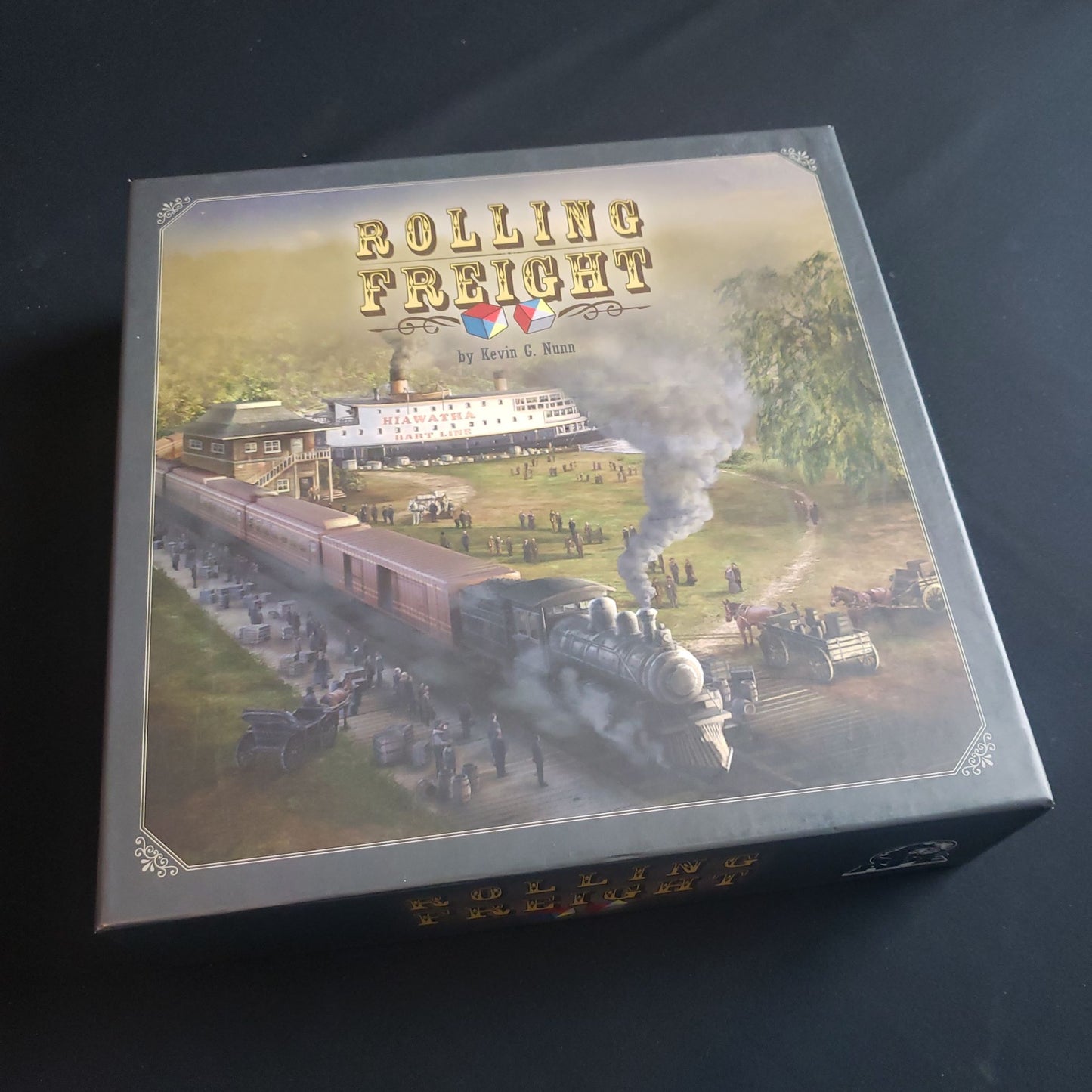 Image shows the front cover of the box of the Rolling Freight board game