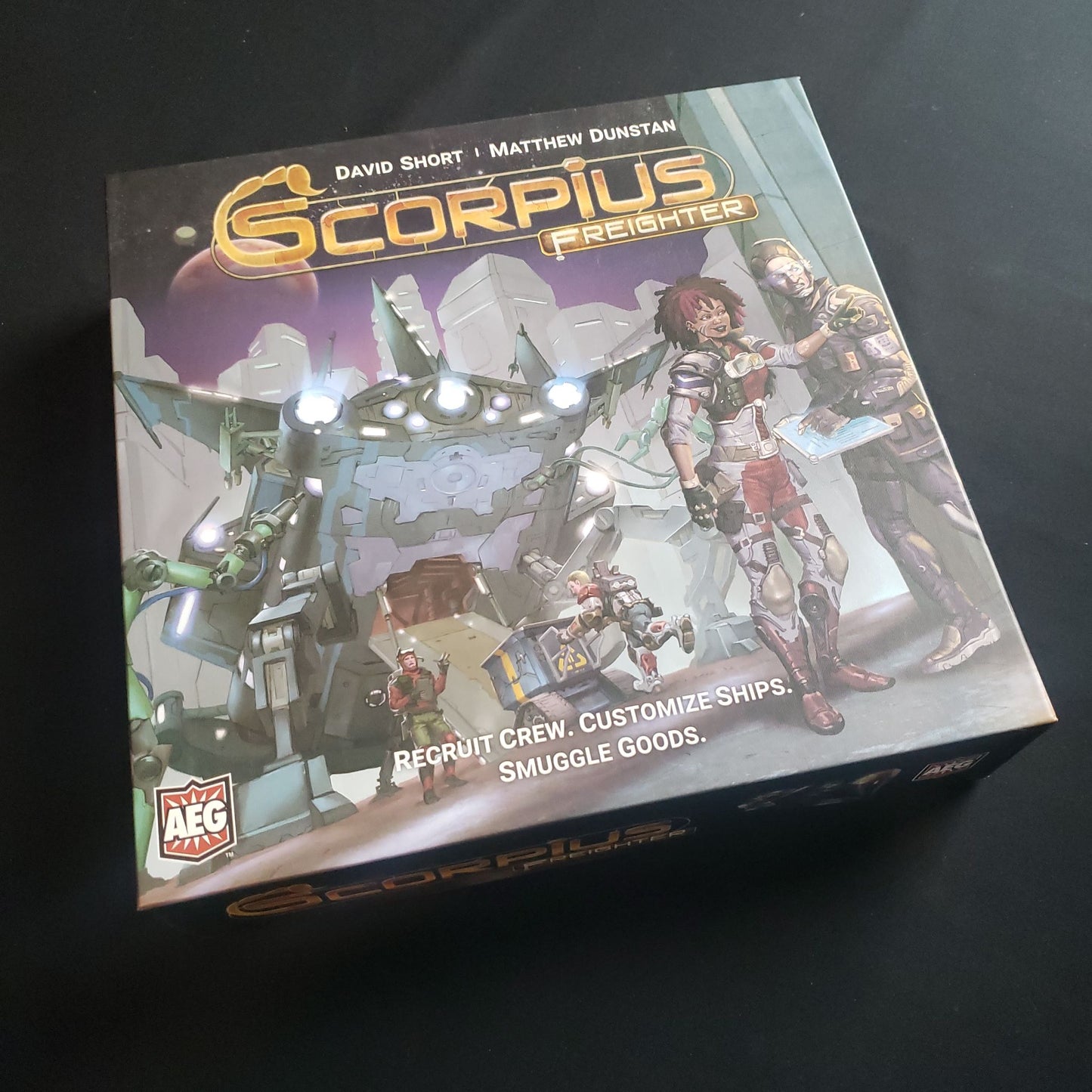 Image shows the front cover of the box of the Scorpius freighter board game