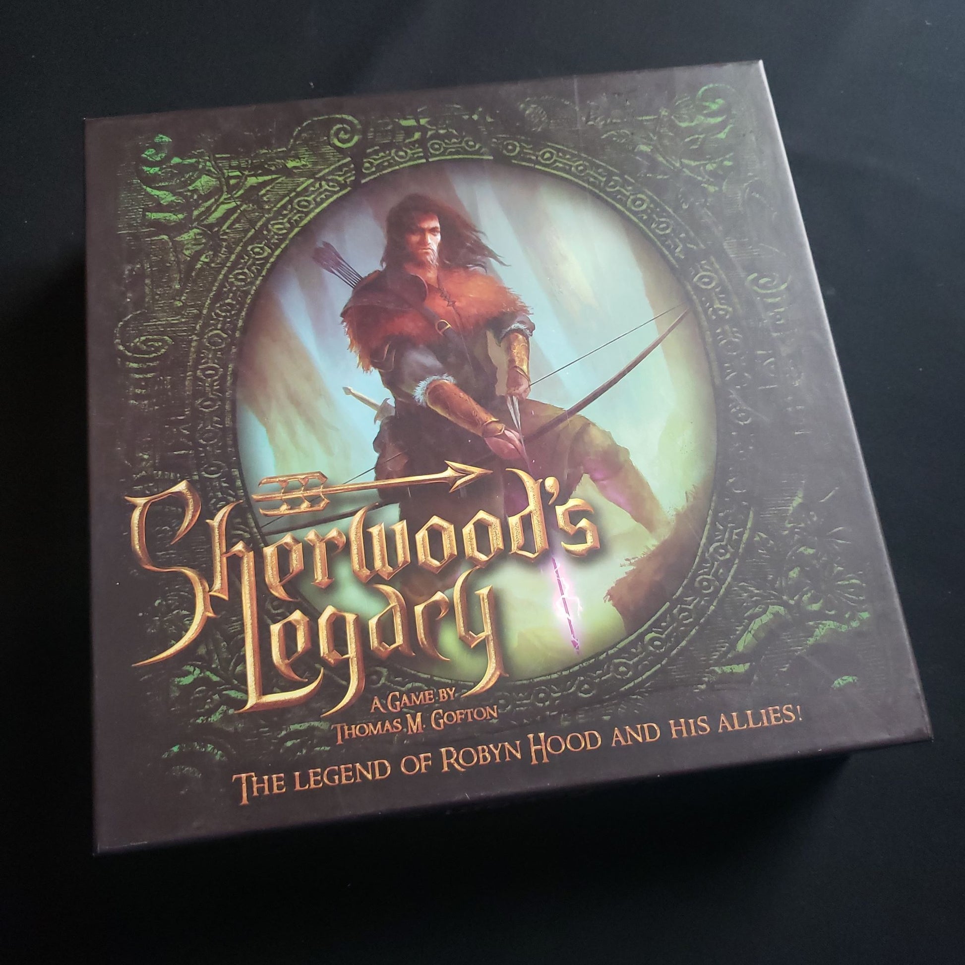 Image shows the front cover of the box of the Sherwood's Legacy board game