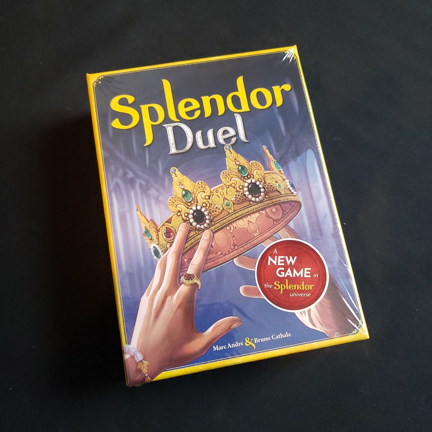 Image shows the front cover of the box of the Splendor Duel board game