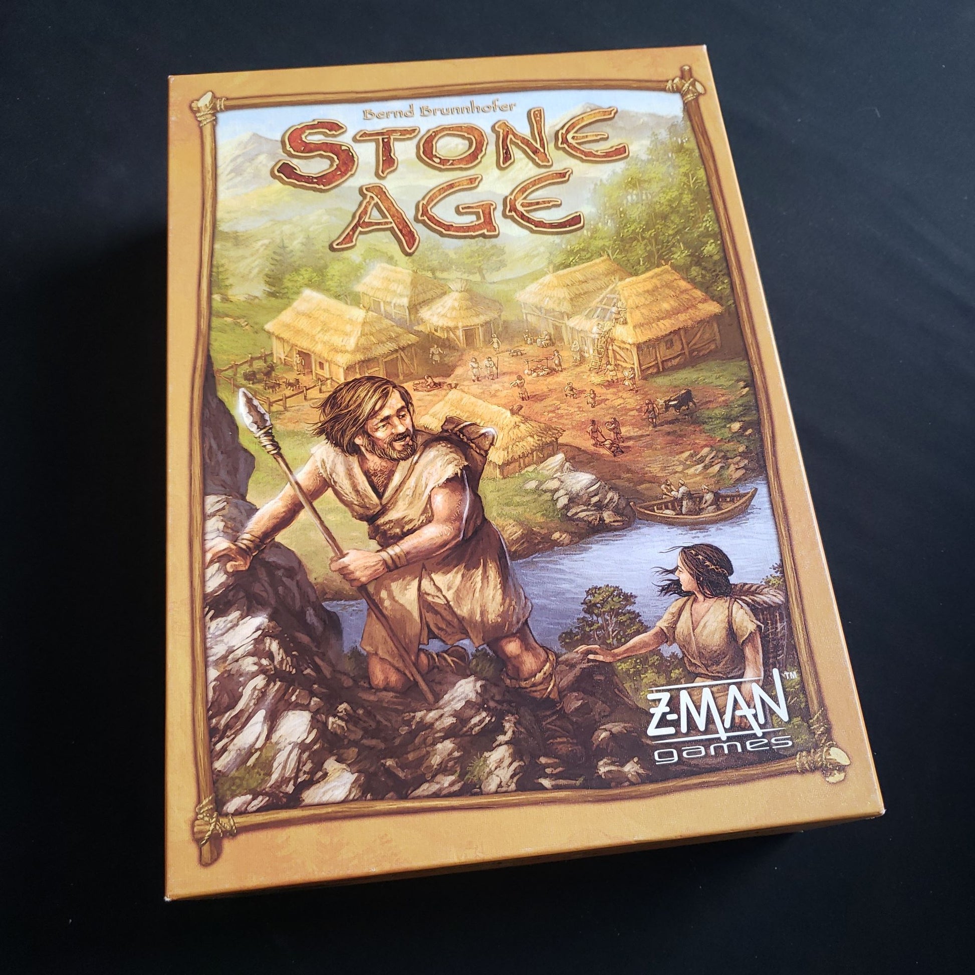 Image shows the front cover of the box of the Stone Age board game