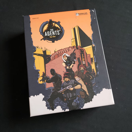 Image shows the front cover of the box of the Agents card game