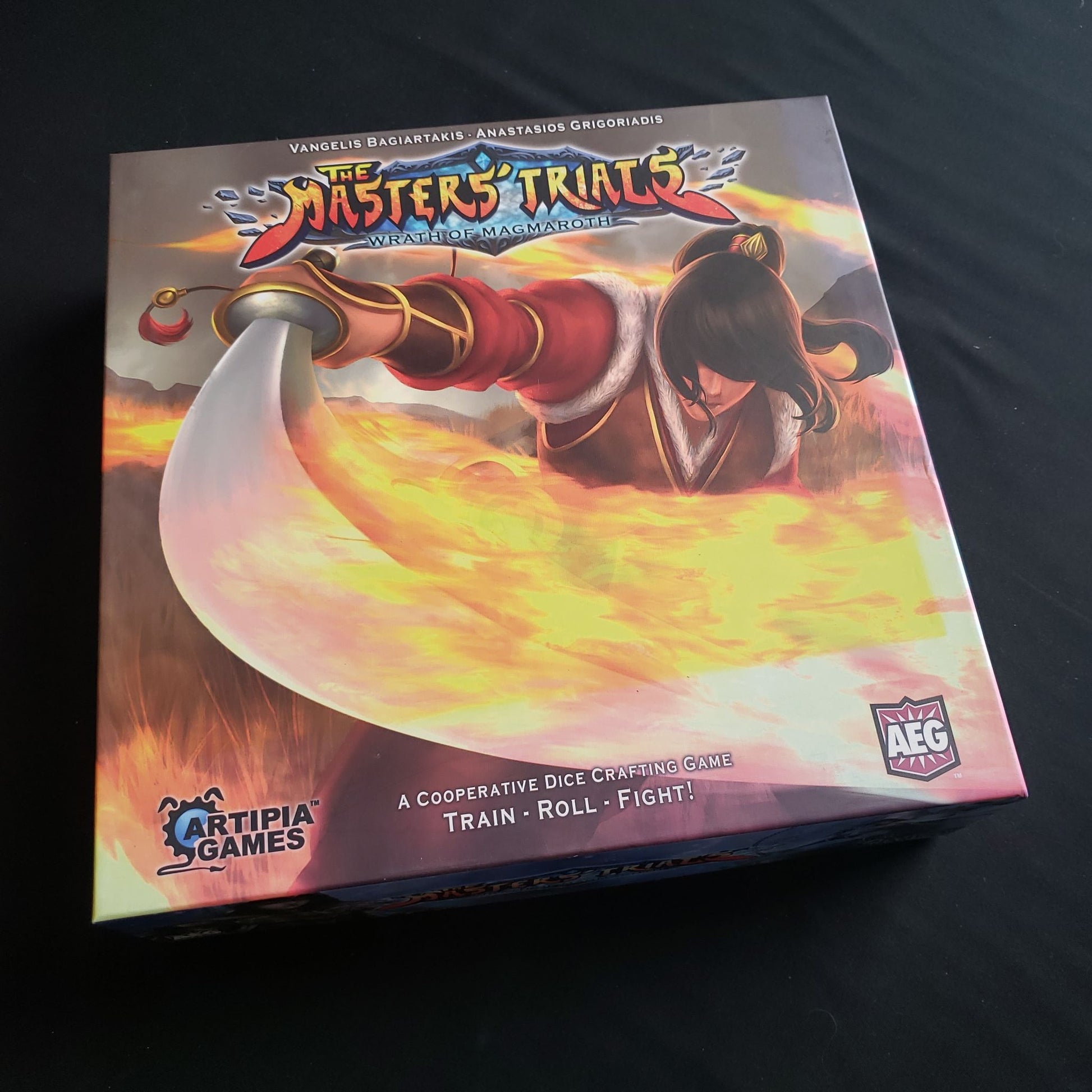 Image shows the front cover of the box of the Masters' Trials board game