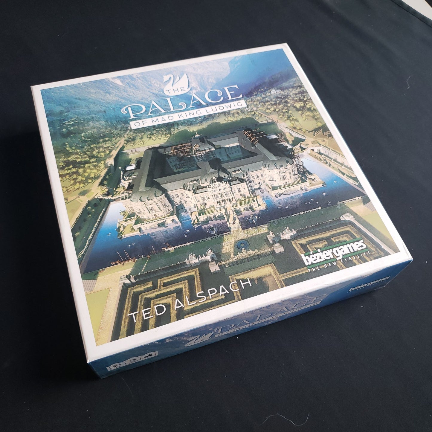 Image shows the front cover of the box of the Palace of Mad King Ludwig board game