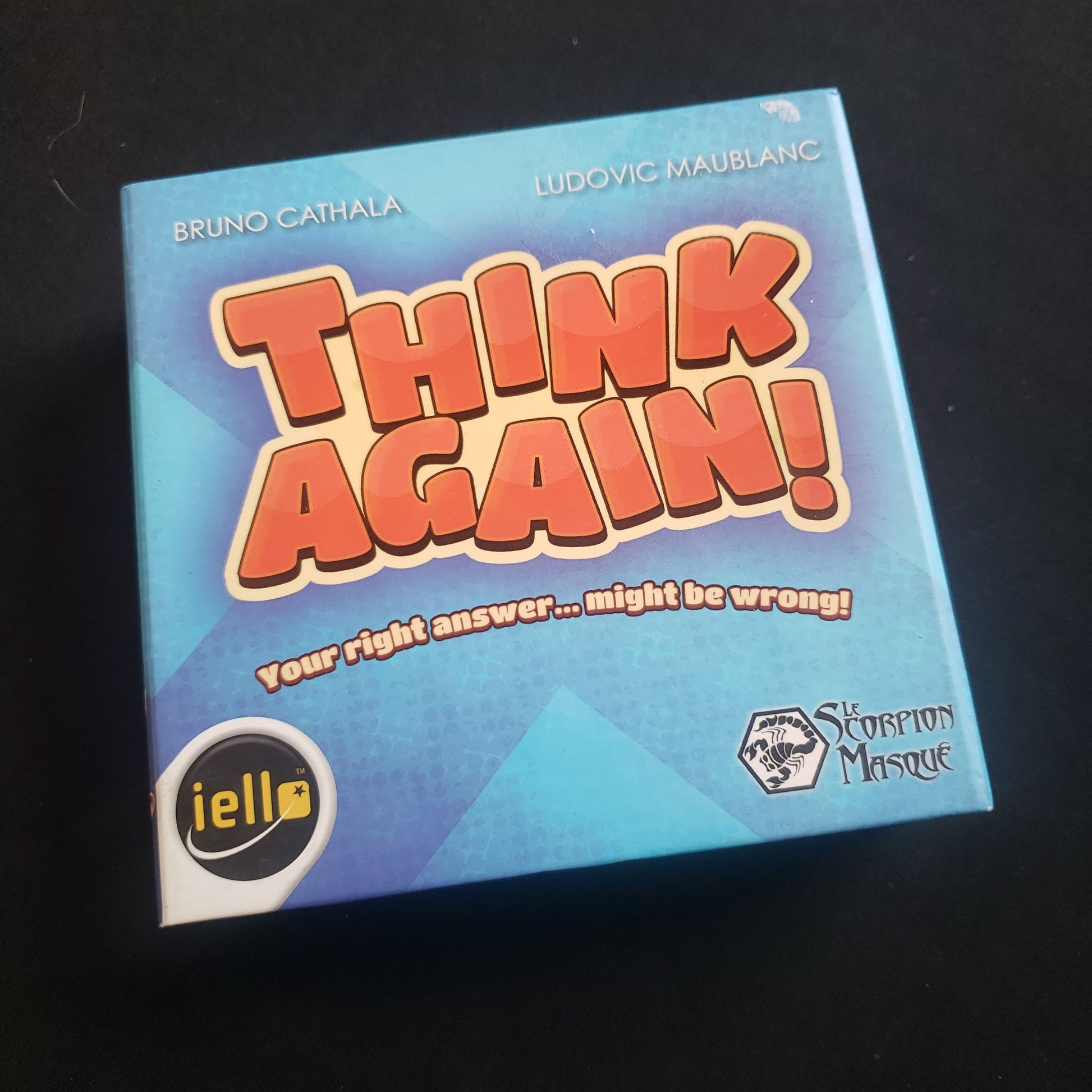 Image shows the front cover of the box of the Think Again card game