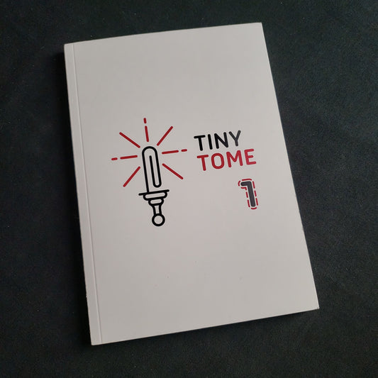 Image shows the front cover of the Tiny Tome: Volume 1 roleplaying game book