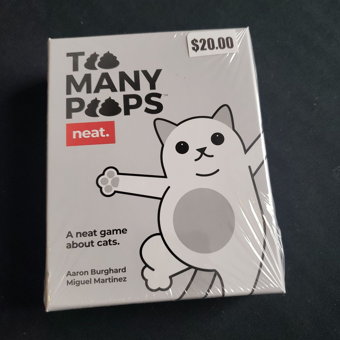 Image shows the front cover of the box of the Too Many Poops card game