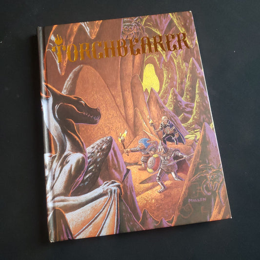 Front cover of the first edition basic rulebook for the Torchbearer roleplaying game