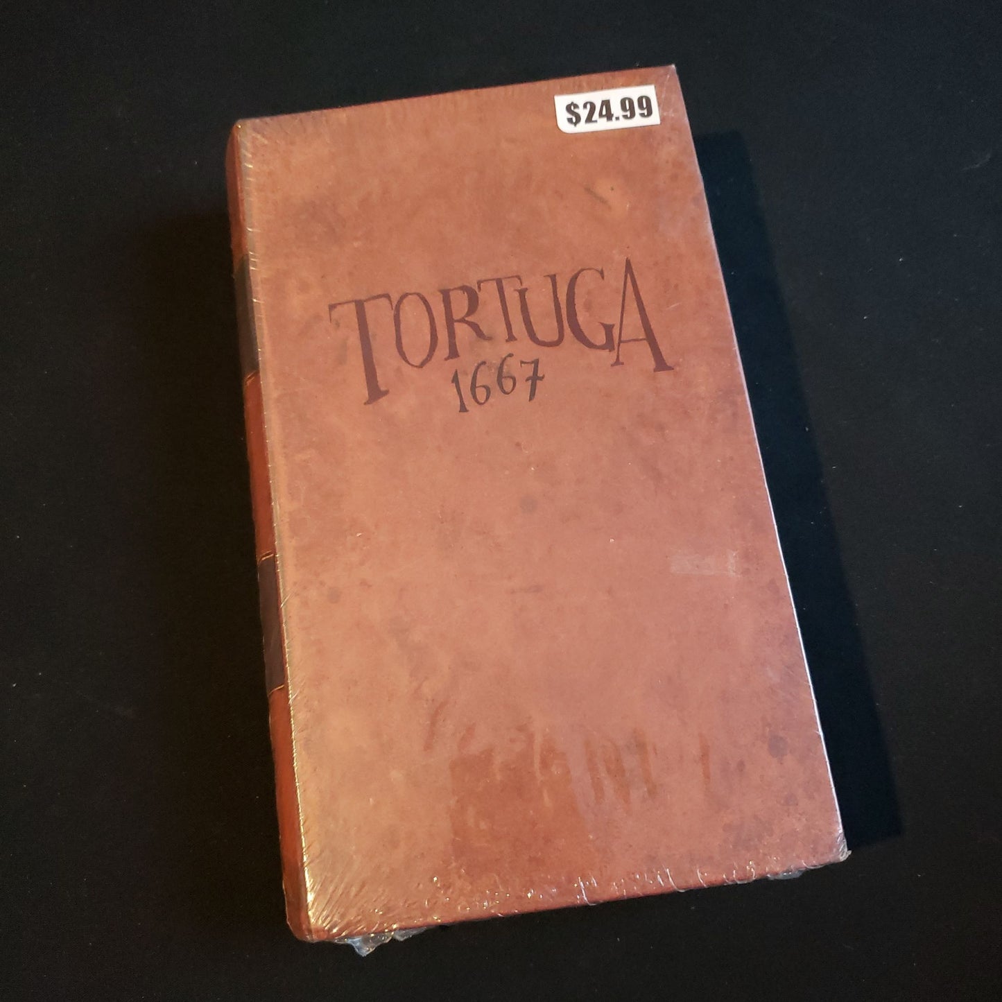 Image shows the front cover of the box of the Tortuga 1667 board game