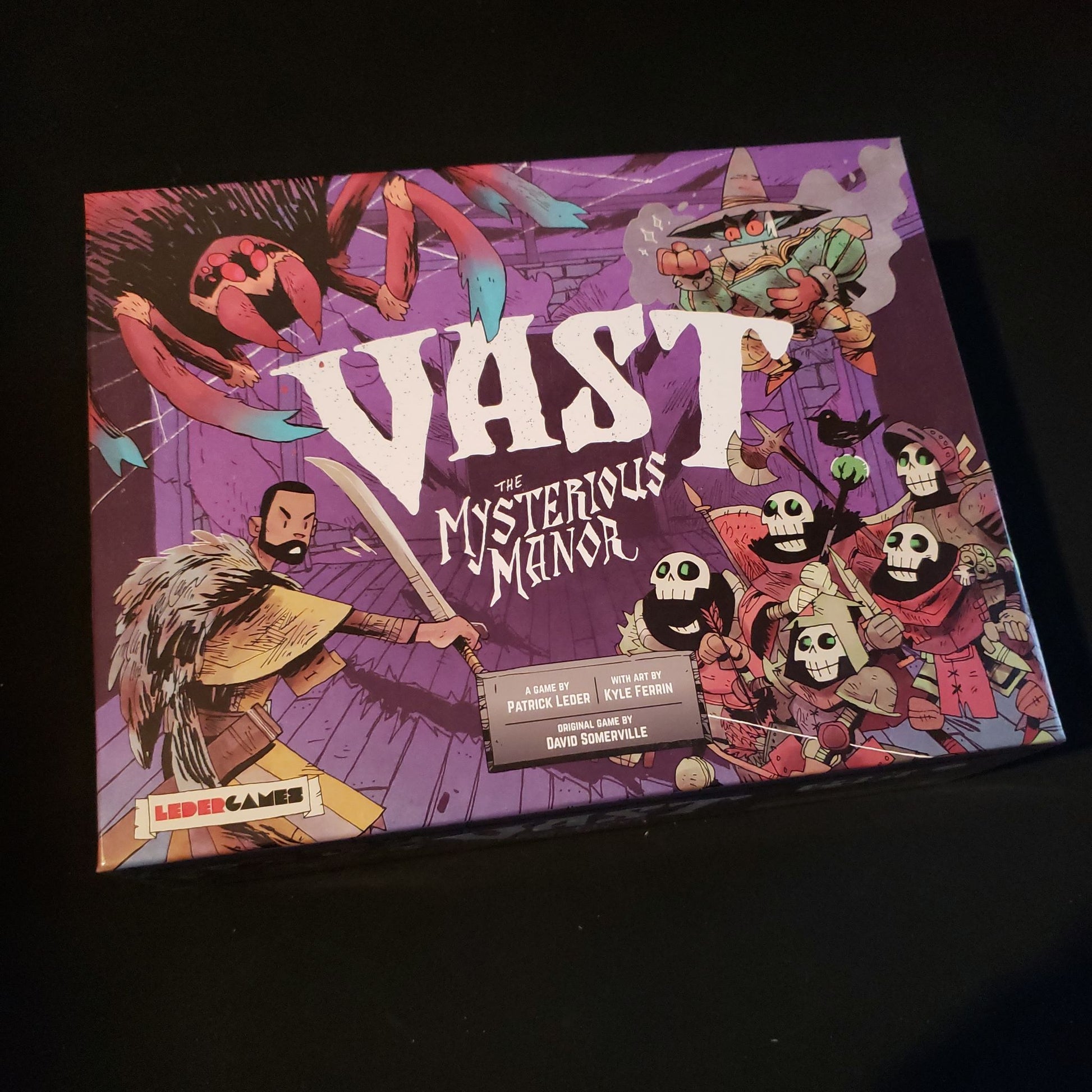 Image shows the front cover of the box of the Vast: The Mysterious Manor board game