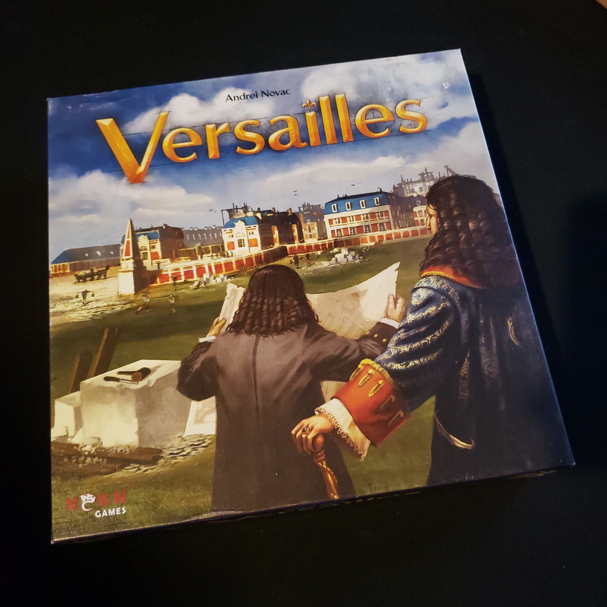 Image shows the front cover of the box of the Versailles board game