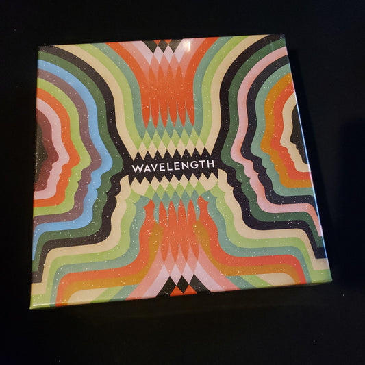 Image shows the front cover of the box of the Wavelength board game