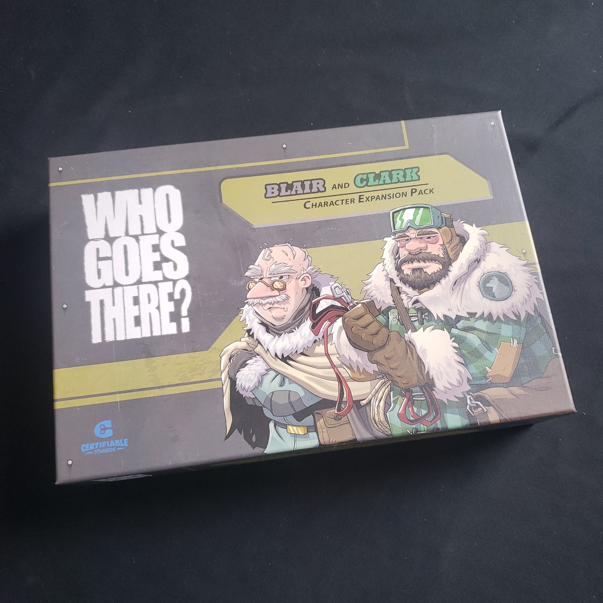 Image shows the front of the box for the Blair and Clark Character Expansion Pack for the Who Goes There board game