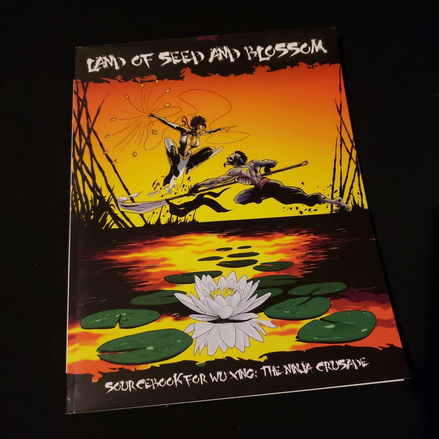 Image shows the front cover of the Land of Seed & Blossom book for the Wu Xing: The Ninja Crusade roleplaying game