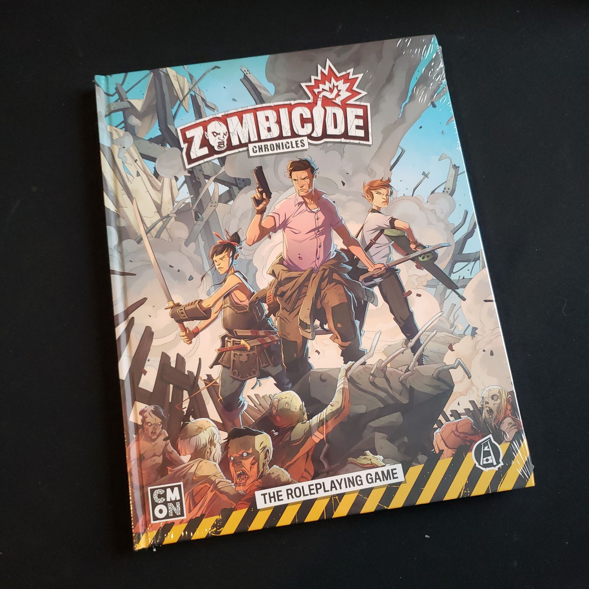 Image shows the front cover of the Core Rulebook for the Zombicide Chronicles roleplaying game